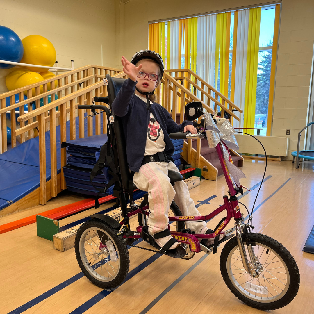 Anika in her new tricycle.